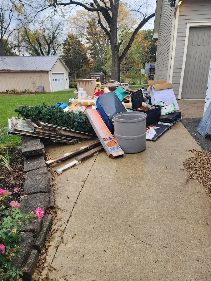 Dumpster being loaded with debris for 30 Yard Dumpster Rental in Lisbon